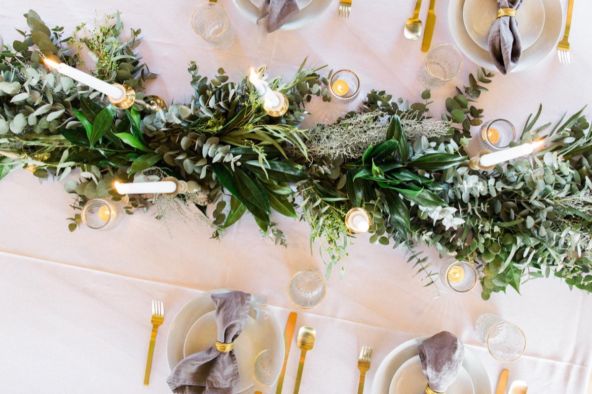 Wedding table setting with greenery and candles at Colorbox Studios